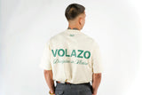 Person wearing a bone creme with 'VOLAZO' branding on the back against a white background