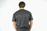Person wearing a charcoal t-shirt with 'VOLAZON' branding on the back against a white background