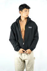 Person wearing a black hoodie with a visible brand logo on a white background